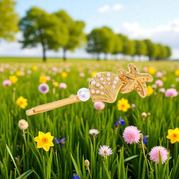 The Coastal Treasure Hair Pin: A golden shell and starfish.